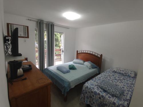 Postel nebo postele na pokoji v ubytování Residencial 101 Ilha Grande