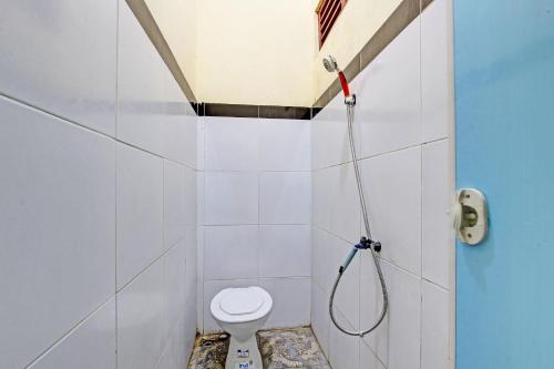 a bathroom with a toilet and a shower at SPOT ON 93007 Guest House Lestari in Prambanan