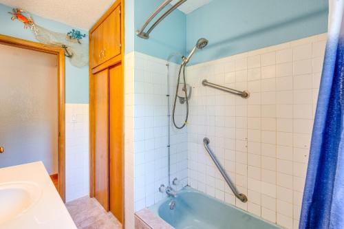 a bathroom with a blue tub and a sink at Pet-Friendly Waterloo Abode with Deck! in Waterloo