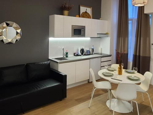 a living room with a black couch and a table at Las Artes Hlius Luxury Apartments in Valencia