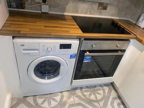 a white washer and dryer in a kitchen at 1 Bedroom Apartment by London Stratford in London