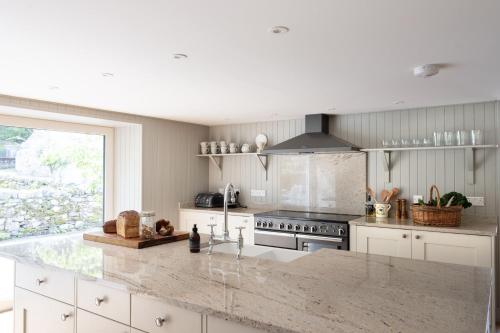 a kitchen with a stove and a counter top at Lassintullich House Main House in Kinloch Rannoch