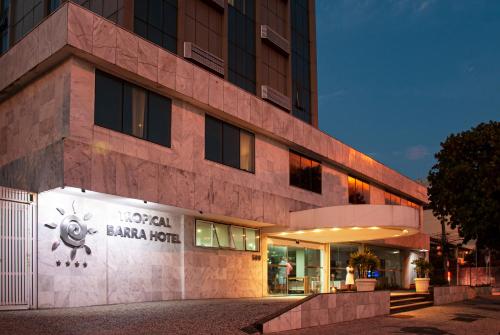 a building with a sign on the side of it at Tropical Barra Hotel in Rio de Janeiro