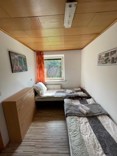 a room with three beds and a window at Four Season Apartment Irene in Eisenerz