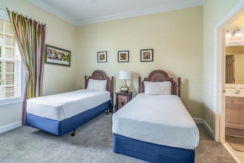 a bedroom with two beds and a window at Avian Forest Four Bedroom, Three Bath, Golf Villa in Pawleys Island