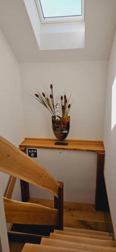 a vase of flowers on a table with a window at AppPrusnik in Ljubljana