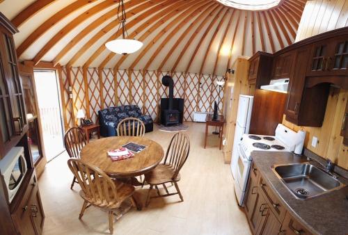 a room with a table and chairs in a yurt at Parc du Mont-Citadelle in Saint-Honoré-de-Témiscouata