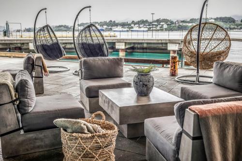 a group of chairs and tables on a patio at Quality Hotel Waterfront in Ålesund