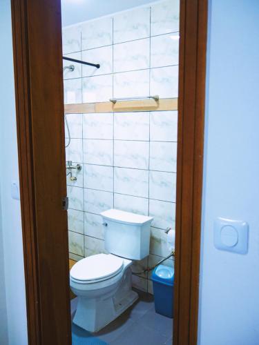 a bathroom with a white toilet in a room at Cecay Apartments Logpom in Douala