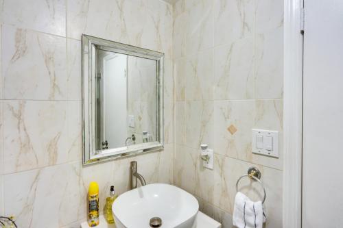 a bathroom with a sink and a mirror at Cozy Albany Vacation Rental about 5 Mi to Downtown! in Albany