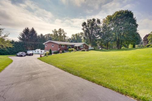 a house with a driveway and a grassy yard at Cozy Albany Vacation Rental about 5 Mi to Downtown! in Albany