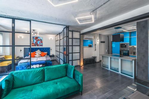 a living room with a green couch and a bed at Unique in Eger