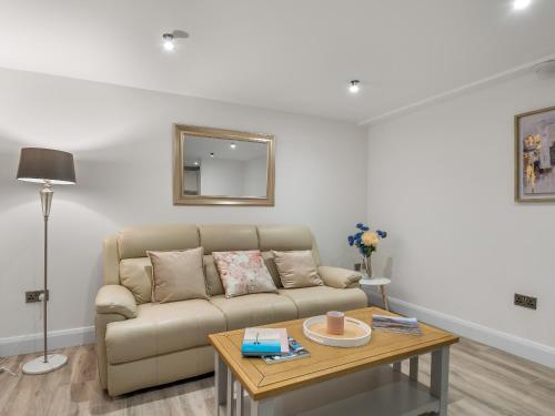 a living room with a couch and a table at Cleggan Pierside Apt 1 in Cleggan