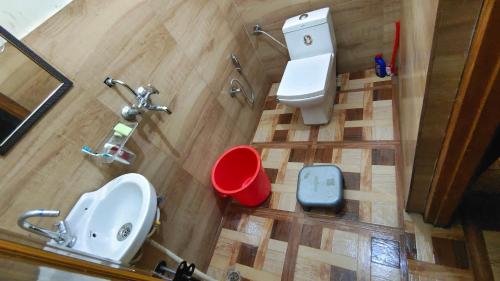 an overhead view of a bathroom with a toilet and a sink at hotel chakrata green and camping in Chakrāta