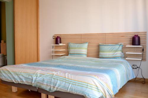 a bedroom with a large bed with a wooden headboard at Lisbon Brown Cozy Apartment in Lisbon