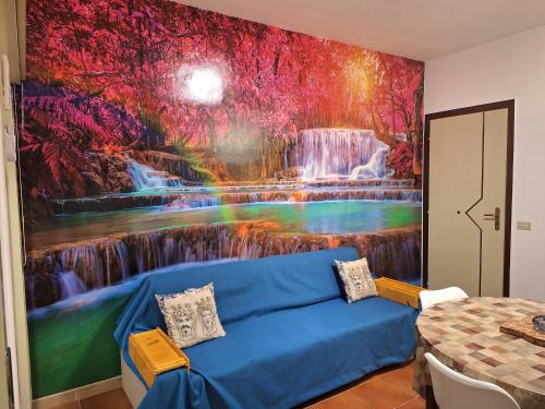 a living room with a waterfall mural on the wall at Maria's - Parking Area, no ZTL, close Train Station and Beach in Cefalù