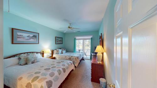 a bedroom with two beds and a window at Beautiful 2BR 2BA Lakeside Villa with Lake Views in Pawleys Island