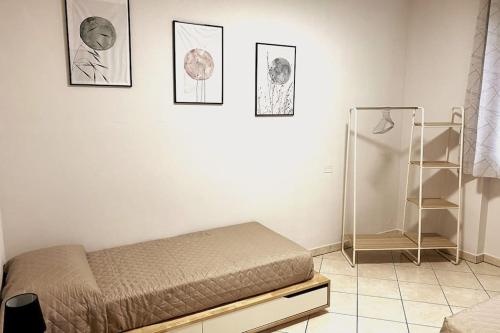 a bedroom with a bed and pictures on the wall at Hygge Holiday House in Luino