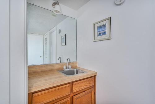 a bathroom with a sink and a mirror at 7051 - Hatteras High 5A by Resort Realty in Rodanthe