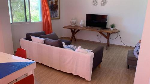 a living room with a couch and a table at La Isla Bonita in Punta Rucia