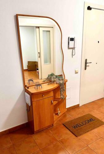 a bathroom with a wooden sink and a mirror at Apartamento St Agustí - Centro in Mataró