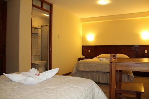 Postel nebo postele na pokoji v ubytování Kaaro Hotel El Buho