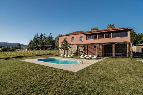 a house with a swimming pool in the yard at Quinta Calheiros - Rural Place in Coucieiro