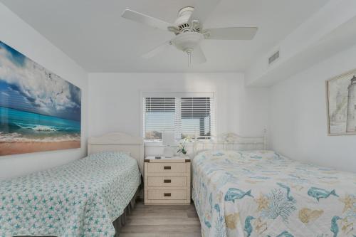 a bedroom with two beds and a ceiling fan at 7080 - Atlantic Paradise by Resort Realty in Rodanthe