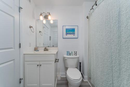 a bathroom with a toilet and a sink and a shower at 7080 - Atlantic Paradise by Resort Realty in Rodanthe