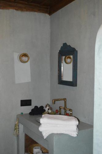 a bathroom with a sink and a mirror at Casa Muse Kastellorizo Whole House in Meyisti