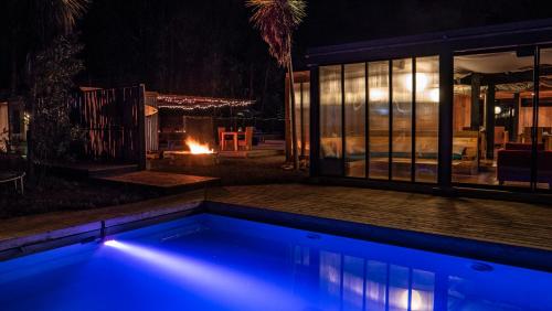 a swimming pool in a backyard at night at Surf Lodge Punta de Lobos in Pichilemu