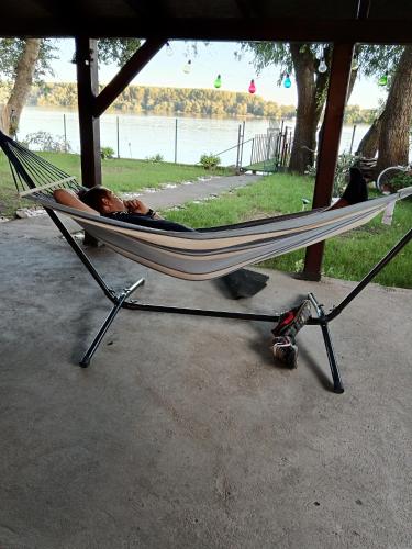 a man laying in a hammock in a park at Vila Marina in Kovin