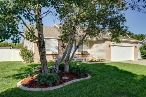 a house with a tree in a yard at Family-Friendly Clearfield Home with Hot Tub! in Clearfield