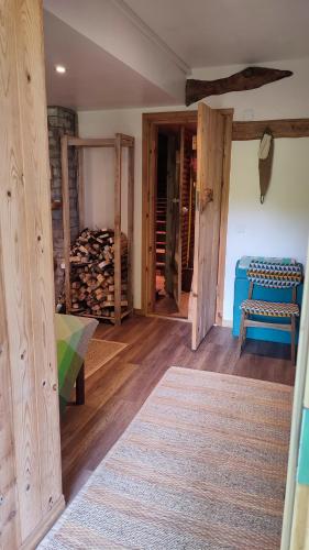 a room with wooden floors and a room with a bed at Viini puhkemaja in Myustelʼ
