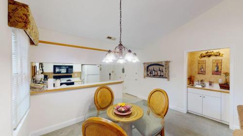 a kitchen and dining room with a table and chairs at Pawleys Plantation Greens 1 Bedroom Retreat in Pawleys Island