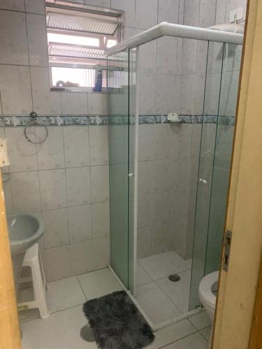 W łazience znajduje się prysznic, umywalka i toaleta. w obiekcie Apartamento de temporada no canto do forte ! w mieście Praia Grande