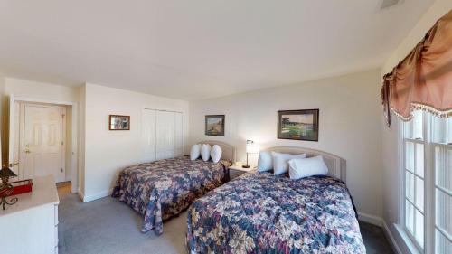a hotel room with two beds and a window at Pawleys Plantation Greens 1 Bedroom Retreat in Pawleys Island