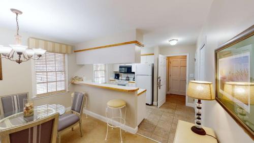 a kitchen with a counter and a dining room at 1-BR Golf Suites Views and Amenities in Pawleys Island