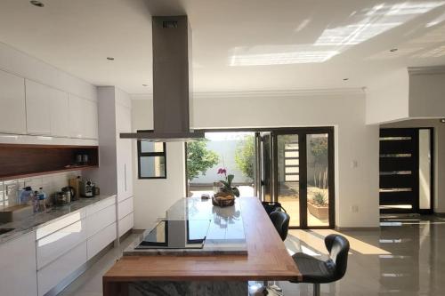a large kitchen with a wooden table in a room at Palm Self Catering - House in Walvis Bay in Walvis Bay