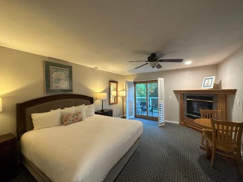 a bedroom with a large bed and a fireplace at Bluebird Inn in Cambria