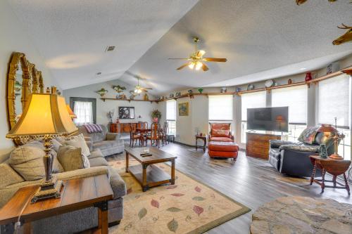 a living room with a couch and a table at Buckhead Cabin with Fireplaces and Private Pool! in Eatonton 
