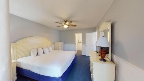 a bedroom with a bed and a ceiling fan at True Blue Villas Your 3BR Oasis in Pawleys Island