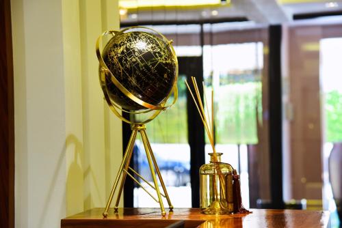 a gold trophy and a vase on a table at MIRANDA HOTEL - Tanger in Tangier