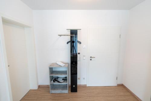 a room with white walls and a closet with a ski rack at Ferienparadies Amadeus in Burtenbach