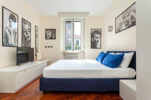 ein Schlafzimmer mit einem großen Bett und einem TV in der Unterkunft Bellezza14 - Appartamento Porta Romana / Bocconi in Mailand