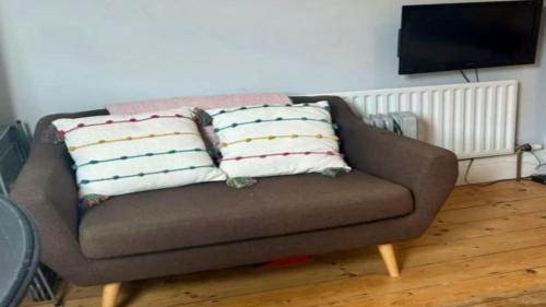 a couch with three pillows on it in a living room at Chalet Platte Solden in Sölden