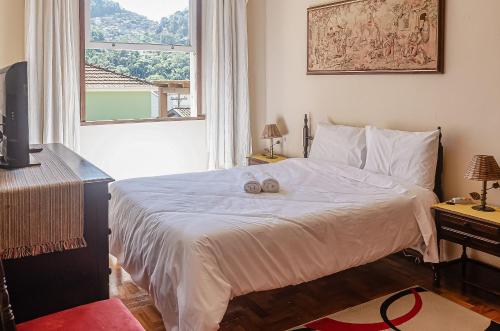 Llit o llits en una habitació de Chamosa e aconchegante casa em Petrópolis VGL041