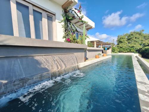 a swimming pool with blue water in front of a house at Casa Jacito in Ayampe