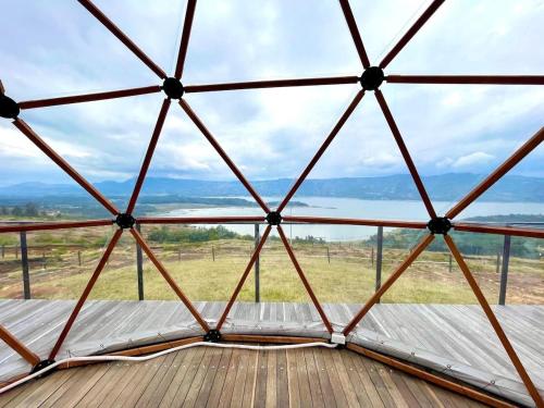 a view from the inside of a yurt with a wooden deck at Lujoso Glamping MarQua Spa Guatavita Wifi Cocina in Guatavita