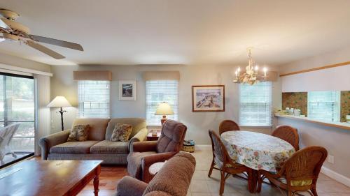 a living room with a couch and a table at Scenic Golf Course Suites Modern 1BR with Balcony in Pawleys Island